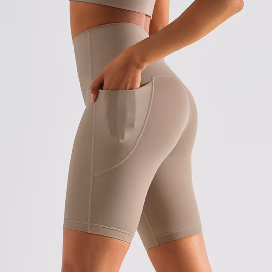 Pantaloncini sportivi da bici da yoga a vita alta da allenamento per donna OEM / ODM all'ingrosso con tasca laterale senza pantaloncini da ciclismo senza cuciture per palestra con punta di cammello